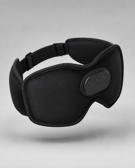 Black electric eye mask with a padded headband and an oval control panel on the side, shown against a neutral gray background.